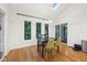 Bright dining room with wood floors, modern light fixture, and view of trees at 8802 W 86Th St, Indianapolis, IN 46278