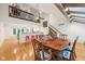 Open floorplan dining room featuring a wood table, hardwood flooring, and a lofted area at 8802 W 86Th St, Indianapolis, IN 46278