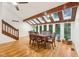 Elegant dining room featuring a wood table, skylights, and large windows offering natural light at 8802 W 86Th St, Indianapolis, IN 46278