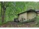 Exterior view of the house with unique architecture nestled amidst a tree-filled and wooded area at 8802 W 86Th St, Indianapolis, IN 46278