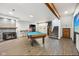 Large basement game room has a pool table, stone fireplace, and stairs leading to the upper floors at 8802 W 86Th St, Indianapolis, IN 46278