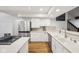 Well-lit kitchen with stainless steel refrigerator, gas range, and white cabinetry at 8802 W 86Th St, Indianapolis, IN 46278