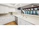 Clean and well-lit kitchen area with white cabinetry, granite countertops, and a stainless steel dishwasher at 8802 W 86Th St, Indianapolis, IN 46278