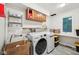 Functional laundry room featuring modern washer and dryer, storage cabinets, and ample counter space at 8802 W 86Th St, Indianapolis, IN 46278