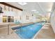 Bright indoor pool with tile surround, access to seating, and a calming environment at 8802 W 86Th St, Indianapolis, IN 46278