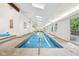 Bright indoor pool with tile surround, access to outdoor deck, and natural light at 8802 W 86Th St, Indianapolis, IN 46278