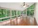 Bright sunroom surrounded by windows, offering serene views of the surrounding lush greenery and a vaulted ceiling at 8802 W 86Th St, Indianapolis, IN 46278