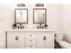 Elegant bathroom features a double vanity with framed mirrors and modern fixtures at 918 S State Ave, Indianapolis, IN 46203