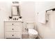 Well-lit bathroom showcases a vanity, mirror, and toilet with modern fixtures at 918 S State Ave, Indianapolis, IN 46203