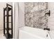 Modern bathroom showcases patterned tile, a bathtub, and modern fixtures at 918 S State Ave, Indianapolis, IN 46203