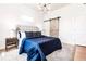 Bedroom with a blue comforter on bed, a barn door, stylish lighting, and neutral walls creating a calming space at 918 S State Ave, Indianapolis, IN 46203