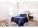 Bright bedroom with a blue comforter on bed, stylish lighting, and neutral walls creating a relaxing retreat at 918 S State Ave, Indianapolis, IN 46203