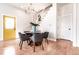 Dining area with modern lighting, table, and chairs, alongside a yellow entrance door, creating a stylish space at 918 S State Ave, Indianapolis, IN 46203
