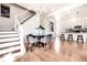 Dining area with modern chandelier, stylish table and chairs, and open layout to the kitchen and staircase at 918 S State Ave, Indianapolis, IN 46203