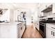 Well-lit kitchen with white cabinets, stainless steel appliances, and hardwood floors, offering a modern culinary space at 918 S State Ave, Indianapolis, IN 46203