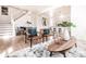 Open-concept living room with kitchen view, hardwood floors, modern furniture, and ample natural light at 918 S State Ave, Indianapolis, IN 46203
