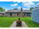 Exterior view of the backyard, including a fire pit and shed with green grass at 926 Brookside Ln, Plainfield, IN 46168