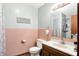 The bathroom features light pink tile, light blue upper walls and a sink with a mirror at 926 Brookside Ln, Plainfield, IN 46168