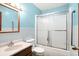 A bathroom featuring a sink, toilet and a shower with sliding glass doors and grab bars at 926 Brookside Ln, Plainfield, IN 46168
