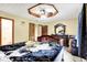 Bedroom featuring dark-stained wood accents, ceiling fan, and access to ensuite bath at 926 Brookside Ln, Plainfield, IN 46168