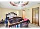 Bedroom featuring dark-stained wood accents, ceiling fan, and access to ensuite bath at 926 Brookside Ln, Plainfield, IN 46168