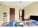 This is another view of the bedroom, showcasing light colored walls, carpet and a blue floral comforter at 926 Brookside Ln, Plainfield, IN 46168