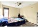 Bright bedroom with light colored walls, carpet and a large window with a blue floral comforter at 926 Brookside Ln, Plainfield, IN 46168