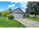 Suburban home with a grey garage door, brick accents, and mature trees at 926 Brookside Ln, Plainfield, IN 46168