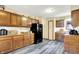 Galley kitchen features dark appliances, wood cabinets and light colored vinyl flooring at 926 Brookside Ln, Plainfield, IN 46168