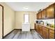 Galley kitchen featuring light-colored vinyl flooring, wood cabinets, and chest freezer at 926 Brookside Ln, Plainfield, IN 46168