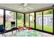 Bright sunroom filled with light, a ceiling fan, and access to the home's backyard at 926 Brookside Ln, Plainfield, IN 46168