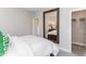 Bright bedroom with an expansive mirror reflecting the bed and ensuite walk in closet at 9352 Corbett Dr, McCordsville, IN 46055