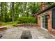 Beautiful back patio featuring stone pavers, brick accents, and serene garden views at 9550 Copley Dr, Indianapolis, IN 46260