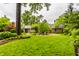 Spacious backyard with well-maintained lawn, mature trees, and charming outdoor seating areas at 9550 Copley Dr, Indianapolis, IN 46260