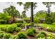 Inviting backyard patio with lush landscaping, lounge furniture, and a charming brick home backdrop at 9550 Copley Dr, Indianapolis, IN 46260