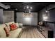 Finished basement with grey walls, white cabinets, recessed lights and vinyl flooring at 9550 Copley Dr, Indianapolis, IN 46260