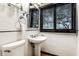 Classic bathroom with subway tile and pedestal sink, offers a clean and timeless aesthetic at 9550 Copley Dr, Indianapolis, IN 46260