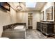 Luxurious bathroom with a soaking tub, double vanity, and custom cabinets at 9550 Copley Dr, Indianapolis, IN 46260
