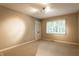 Bright, carpeted bedroom features a window offering lots of natural light at 9550 Copley Dr, Indianapolis, IN 46260