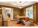 Dining room featuring hardwood floors, a round table, and view to the hallway at 9550 Copley Dr, Indianapolis, IN 46260