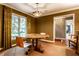 Dining room with hardwood floors, round table, modern chandelier, and backyard view at 9550 Copley Dr, Indianapolis, IN 46260