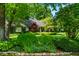 Lovely landscaped front yard of this home has a well maintained lawn and mature shrubs at 9550 Copley Dr, Indianapolis, IN 46260