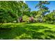 A charming home nestled among lush greenery, featuring a manicured lawn and beautiful mature trees, creating a picturesque setting at 9550 Copley Dr, Indianapolis, IN 46260