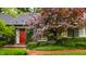 Charming front entry with a red door, brick path, and manicured landscaping at 9550 Copley Dr, Indianapolis, IN 46260