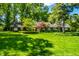 Beautiful single story home with mature trees and lush green lawn at 9550 Copley Dr, Indianapolis, IN 46260