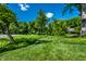 Expansive green lawn with mature trees and manicured landscape at 9550 Copley Dr, Indianapolis, IN 46260
