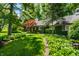 Landscaped front yard features lush gardens and a well-manicured lawn at 9550 Copley Dr, Indianapolis, IN 46260