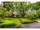 Home exterior with lush landscaping, mature trees and manicured lawn at 9550 Copley Dr, Indianapolis, IN 46260