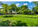 Sprawling lawn with mature trees partially obscuring home and garage at 9550 Copley Dr, Indianapolis, IN 46260