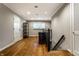 Bright hallway with hardwood floors, built-in speakers, and a staircase at 9550 Copley Dr, Indianapolis, IN 46260